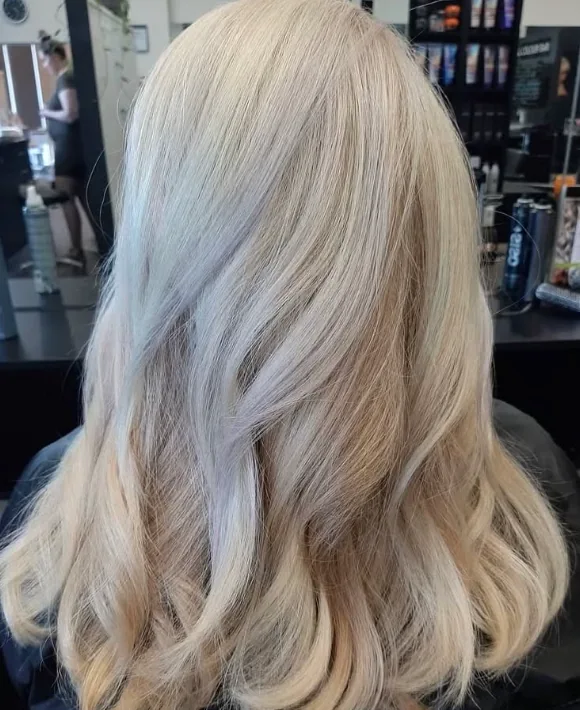 Soft clean blonde hair finished with loose movement