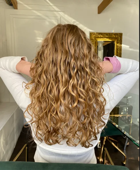 Long blonde curls with natural movement