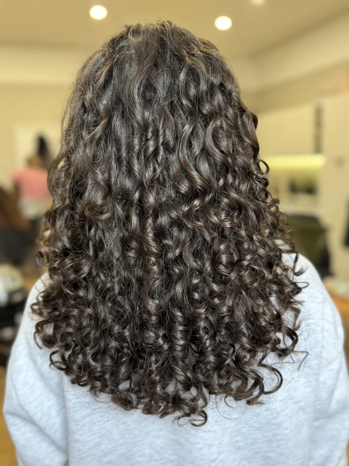 Long glossy brunette ringlets styled by Cas